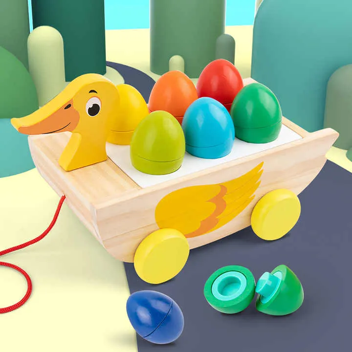 لعبة خشبية ثلاثة في واحد مقطورة بطة مكعب . Three-in-one wooden toy trailer duck cube
